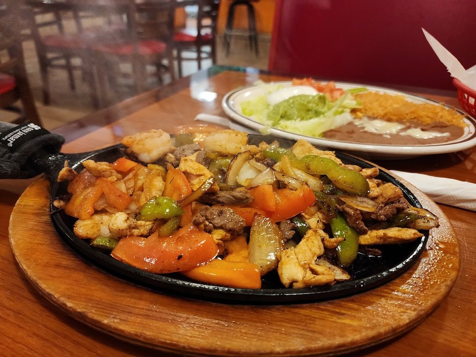 Shared plates and drinks on a restaurant table.